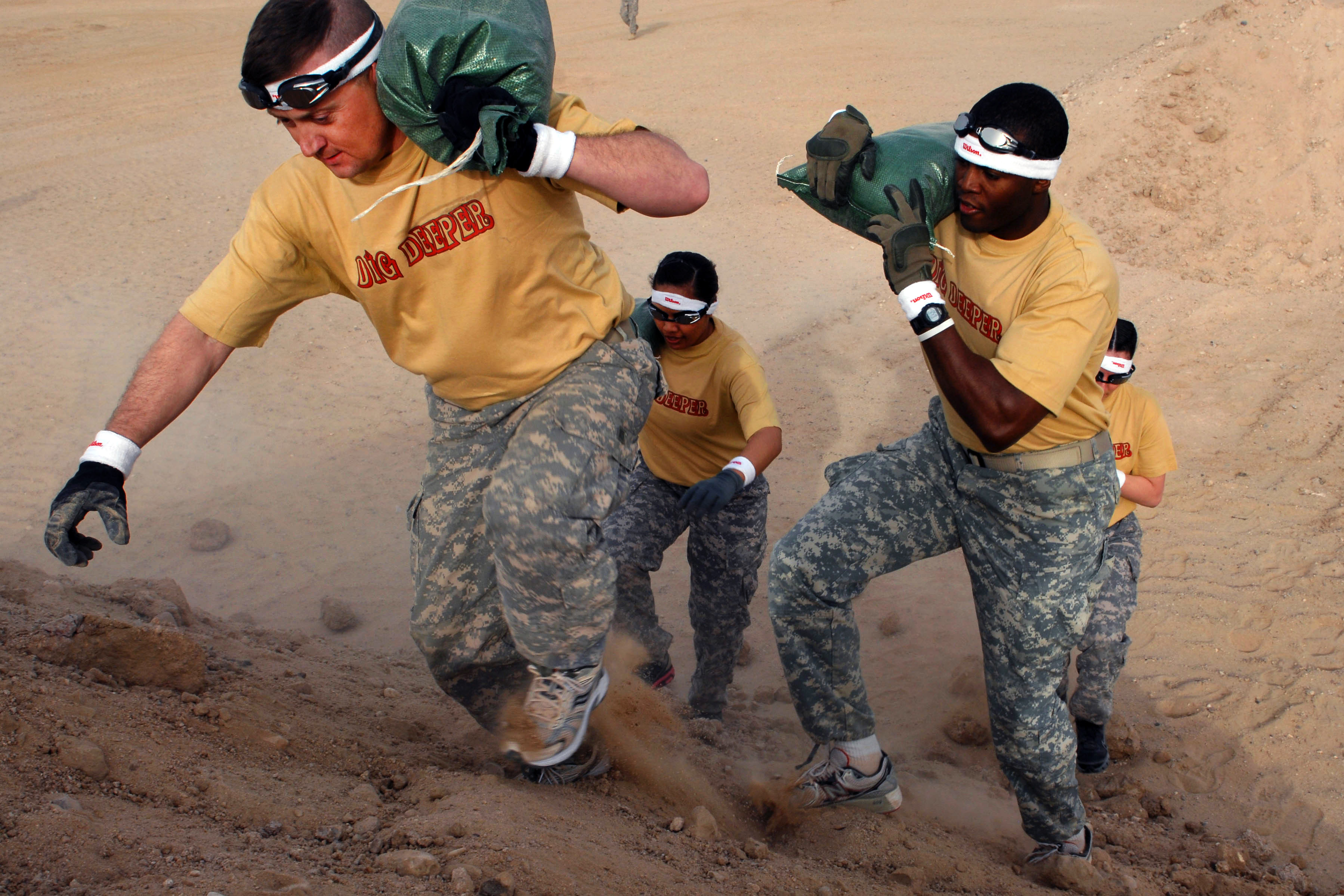 Loaded carries with a sandbag running over a dirt hill